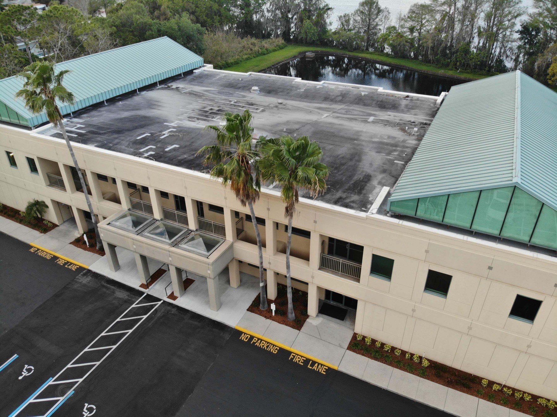 Commercial building on Fairbanks Avenue in Orlando before roof coating, showing a weathered surface