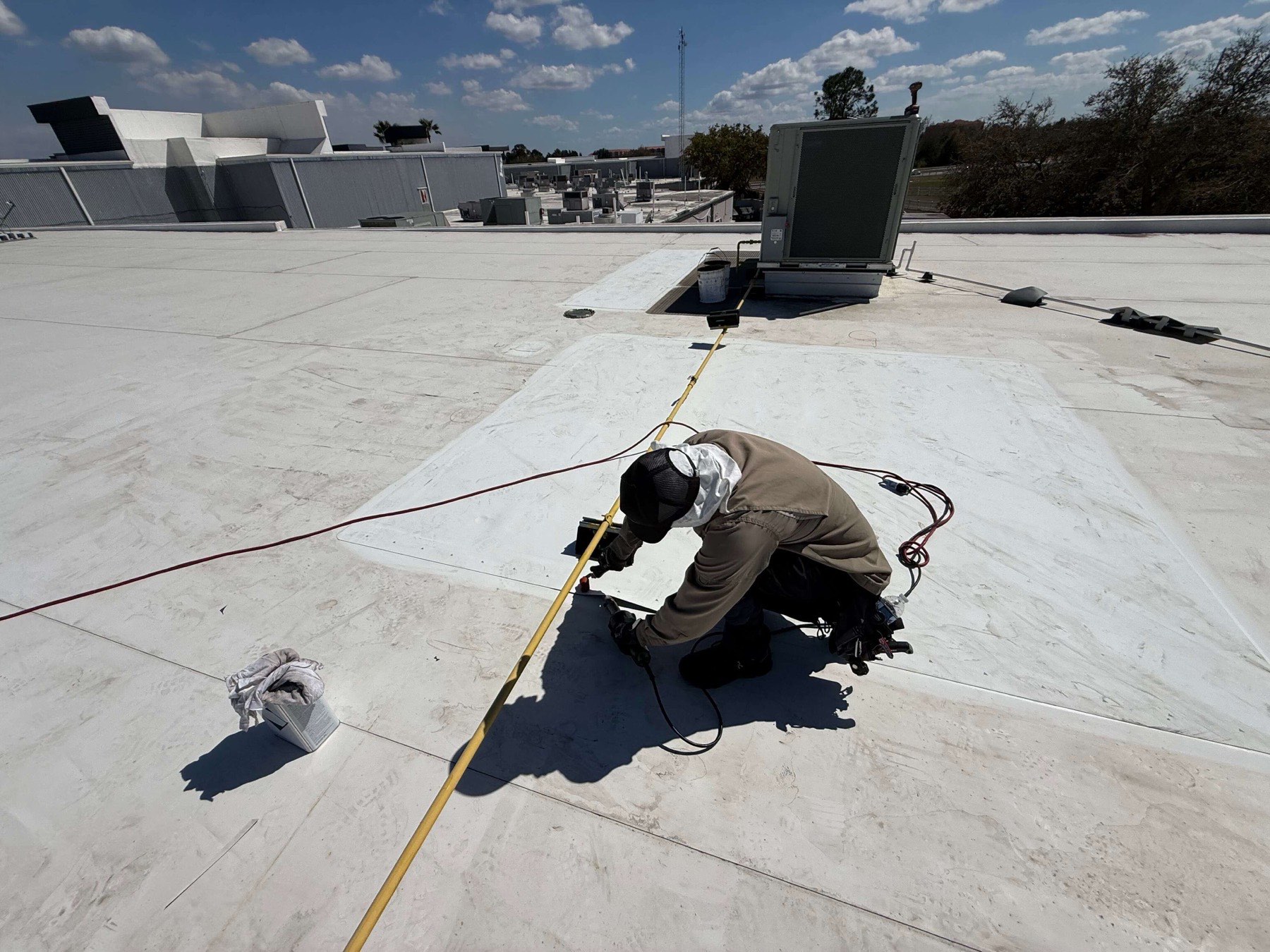Commercial roof repair in progress at a crush yard facility in Davenport, Florida